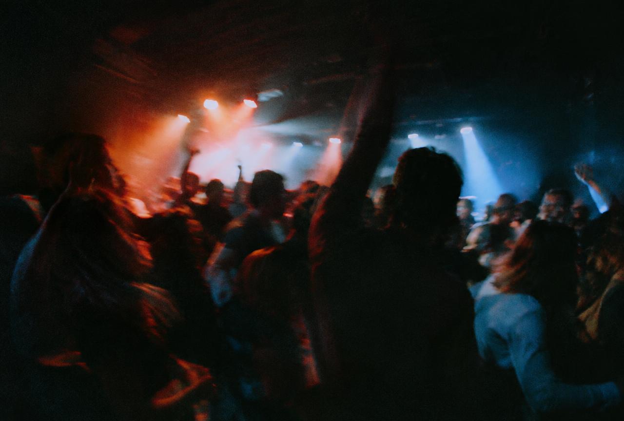 Crowd dancing under stage lights